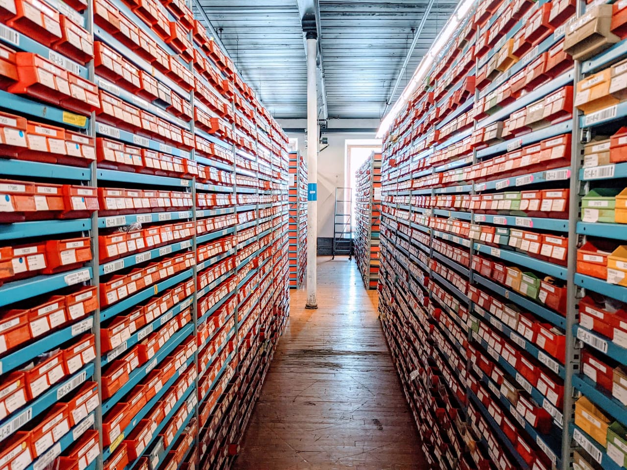Warehouse aisle between dense storage racks